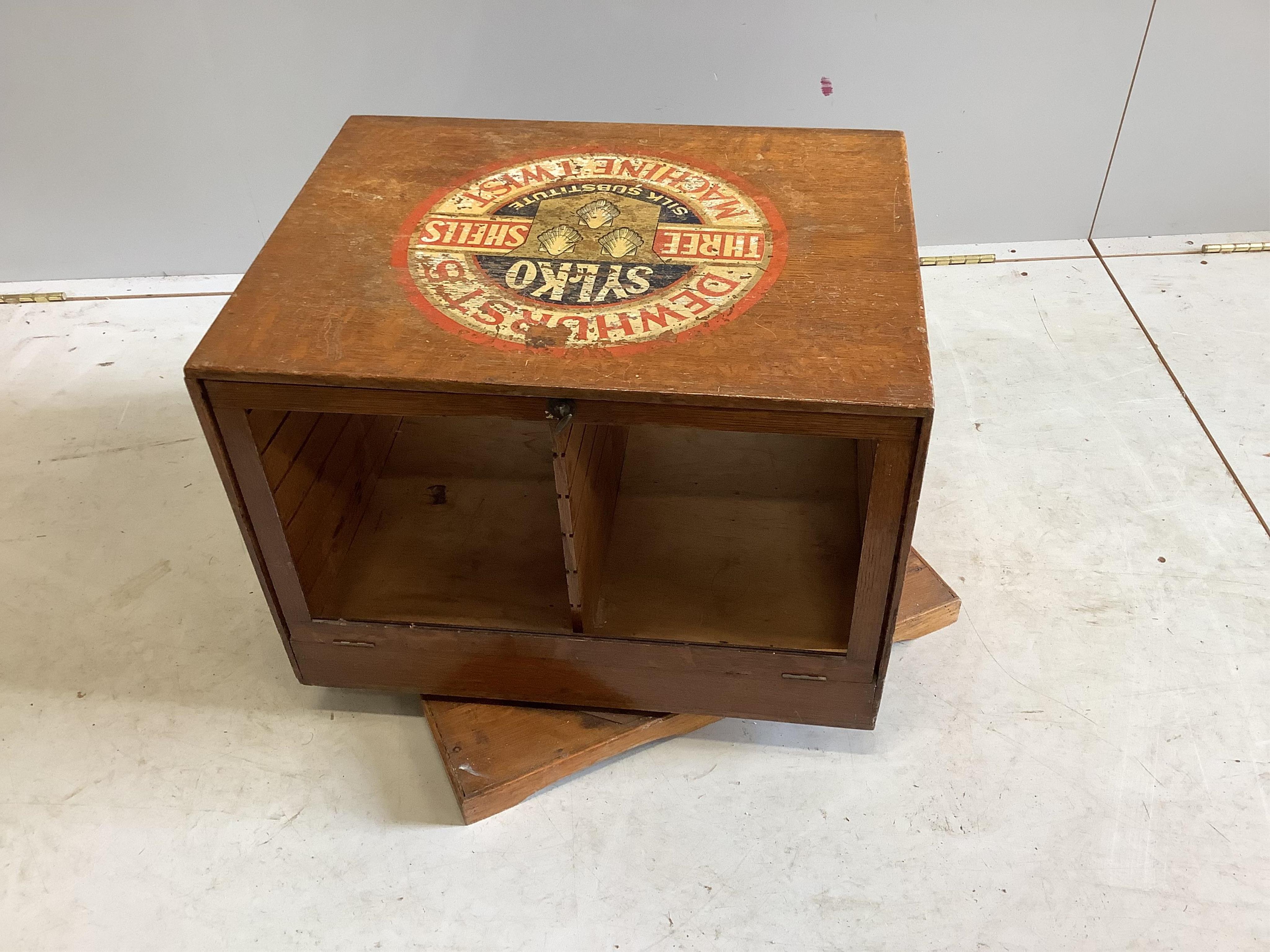 An early 20th century oak counter top display case, “Dewhurst’s Sylko Three Shells Machine Twist”, on swivel base, width 54cm, depth 52cm, height 42cm. Condition - fair